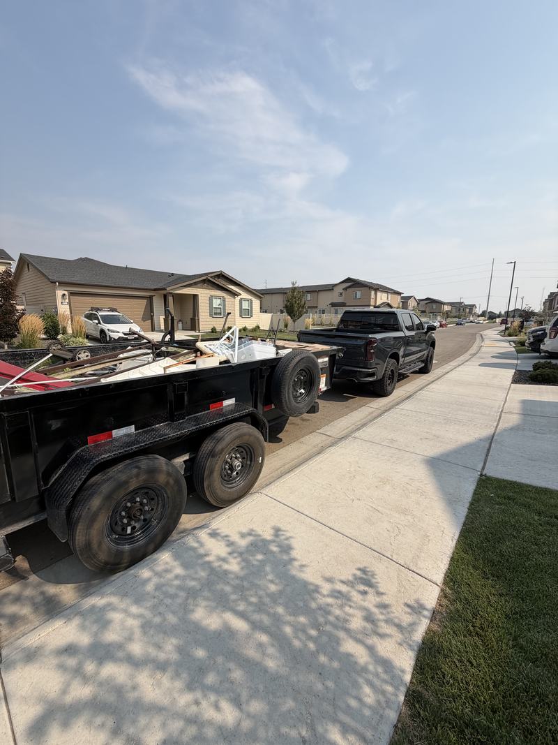 HaulWorks trailer loaded during a cleanout job, parked in a Meridian, Idaho neighborhood