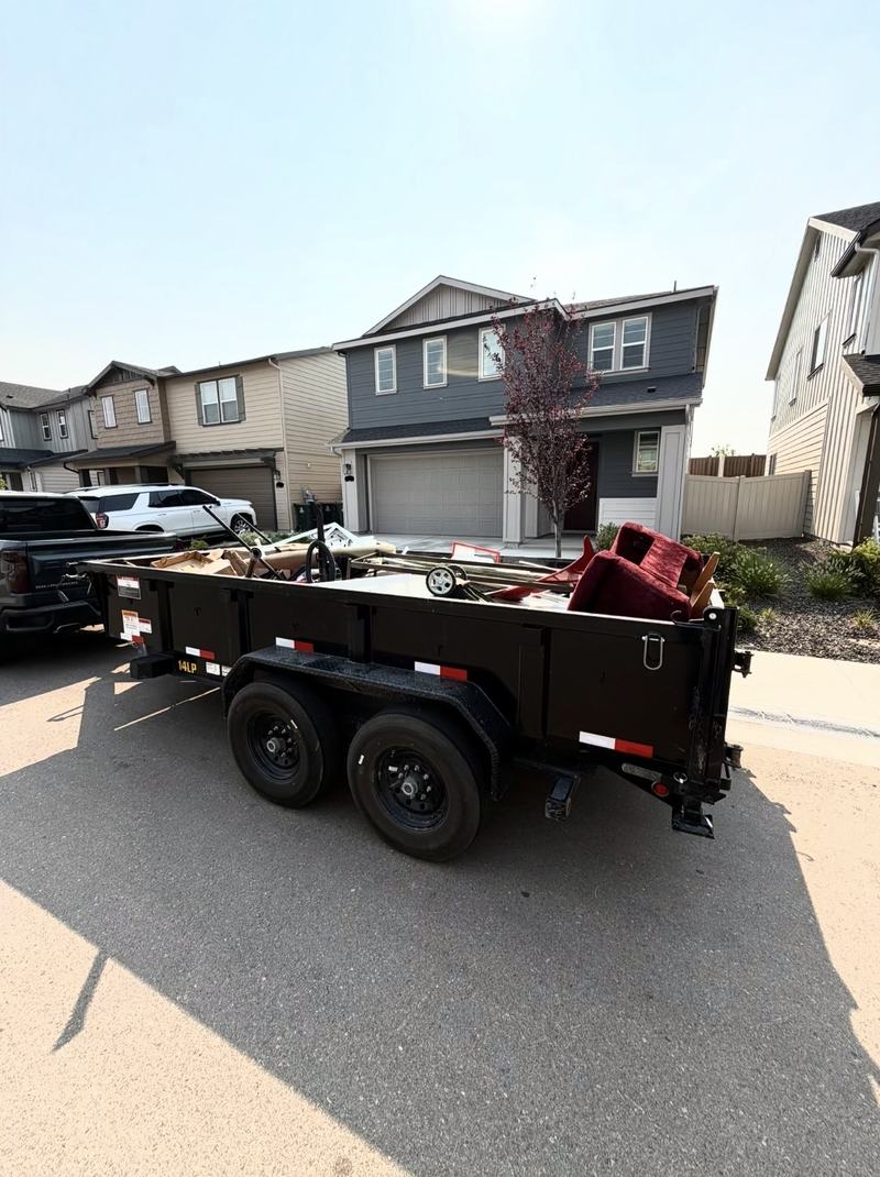 HaulWorks trailer loaded with a couch and furniture during a junk removal job in Meridian, Idaho